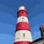 The same lighthouse at 64 by 64 pixels, with windows and the edge of a roof